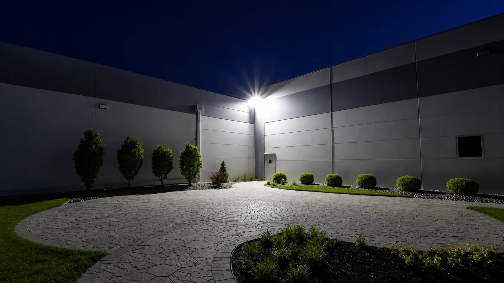 Outdoor flood and area lighting installed around an open site.