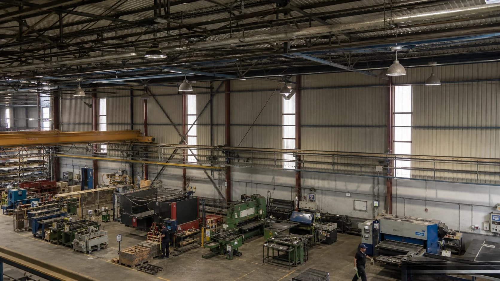 Existing industrial ceiling and work area with old fixtures, circuits or mounting points clearly documented; use an honest survey image, not a fabricated before-and-after.