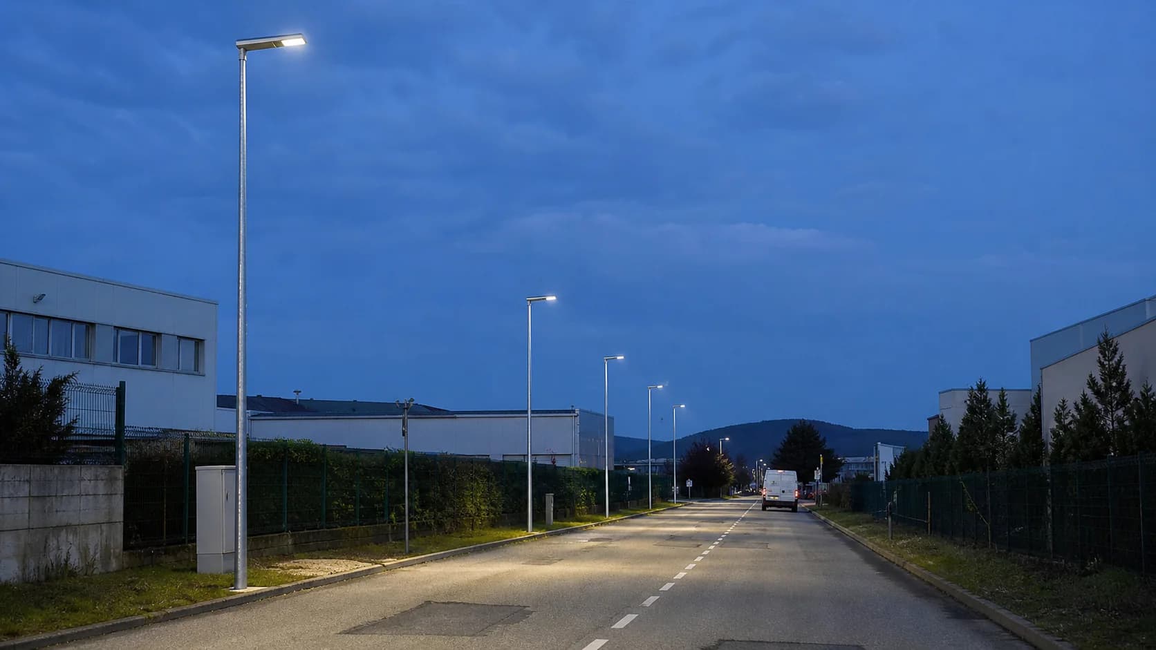 Real roadside solar lighting installation with panel orientation, pole, luminaire and surrounding horizon clearly visible; photograph in representative seasonal conditions.