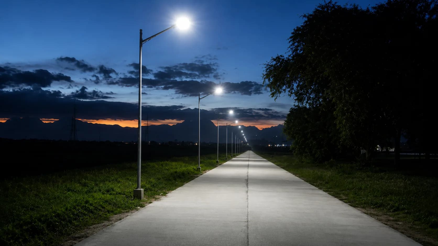 Solar street lighting poles installed along an outdoor roadway.